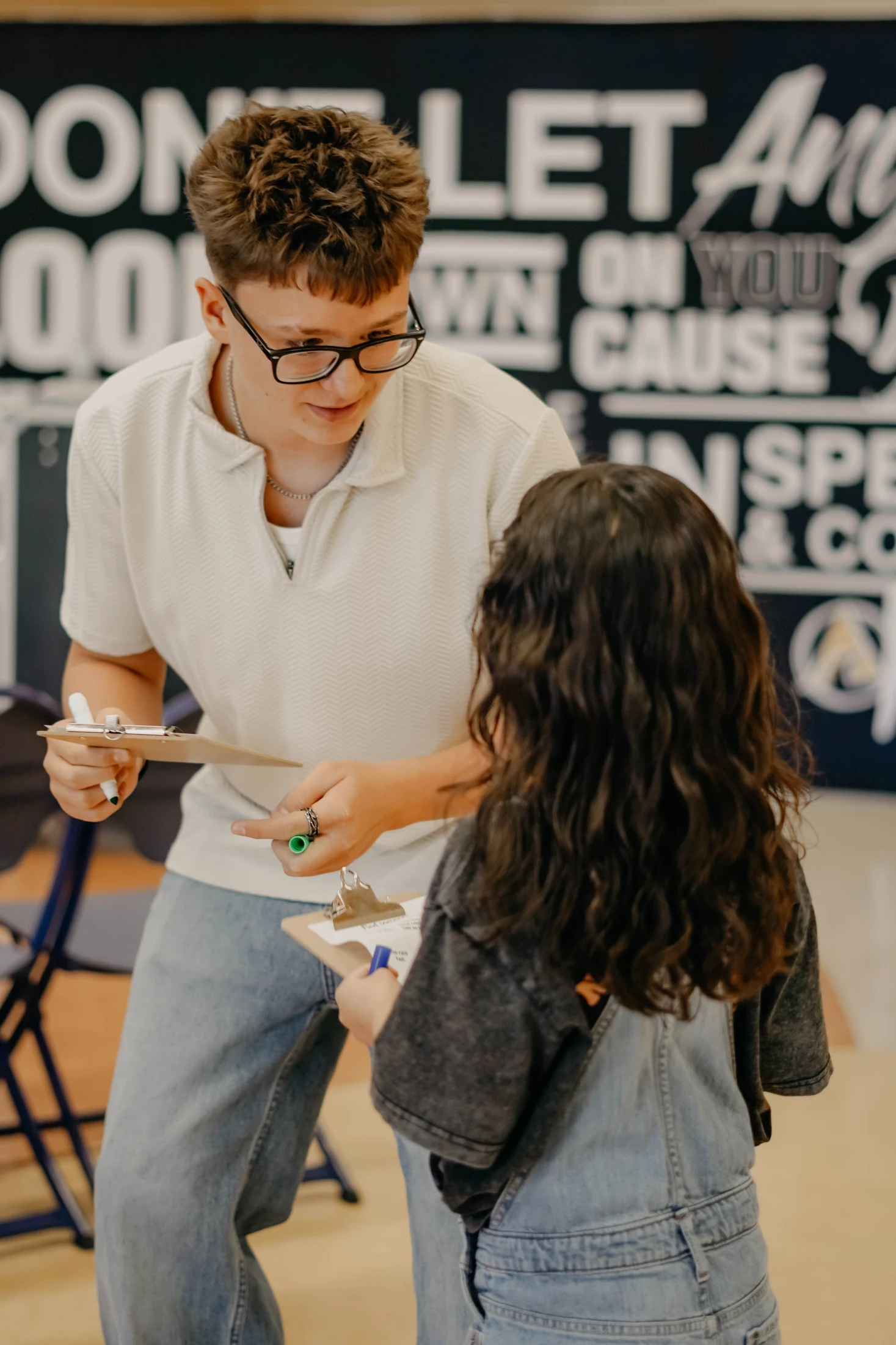 An Avenue Kids volunteer helping a child with an activity