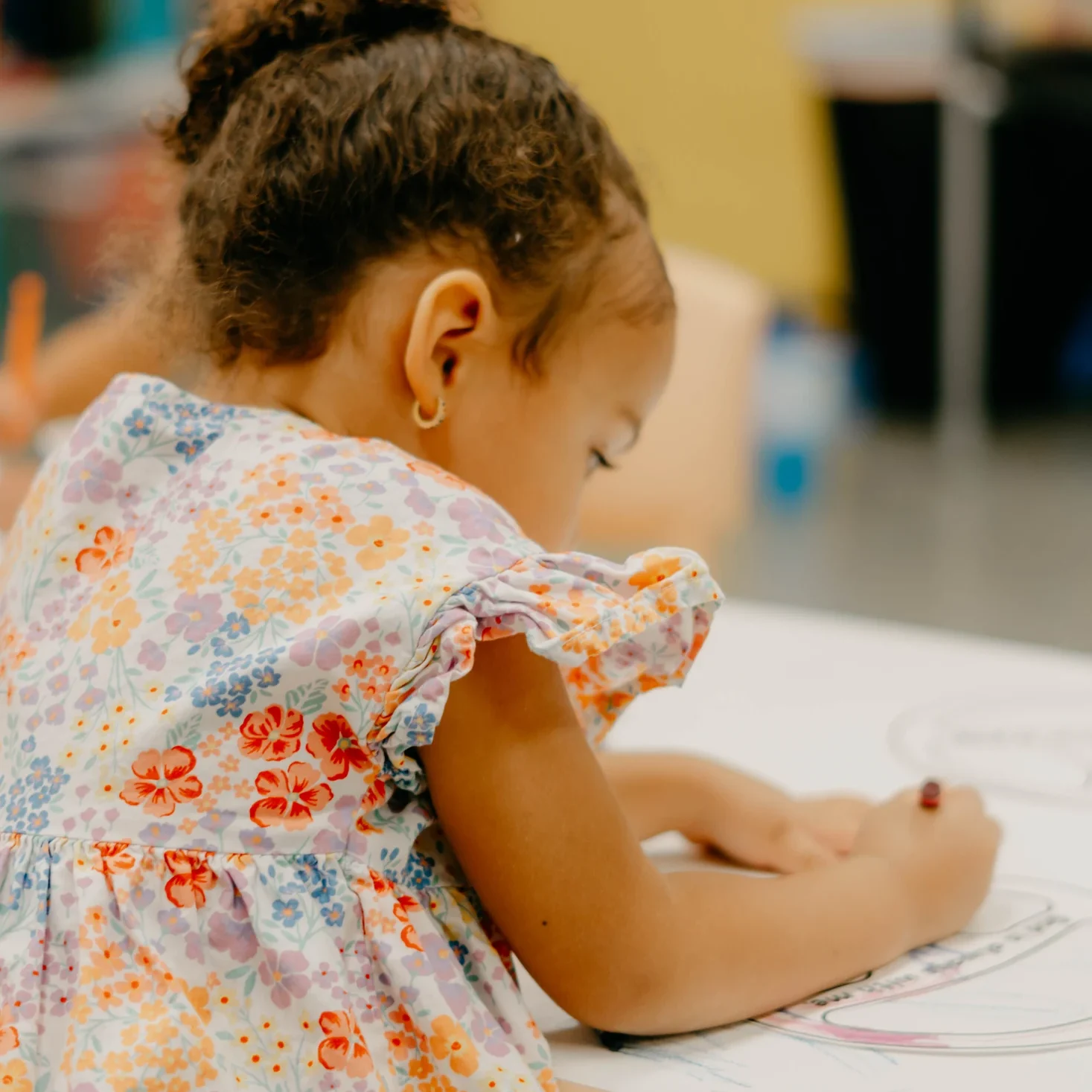 A girl coloring during Avenue Kids