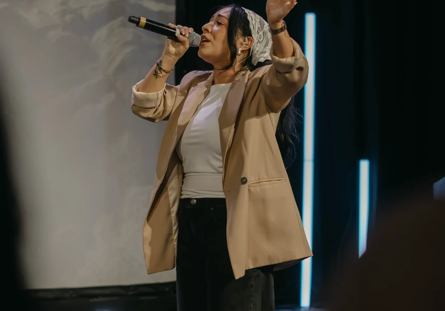 A singer leading worship at Avenue Church