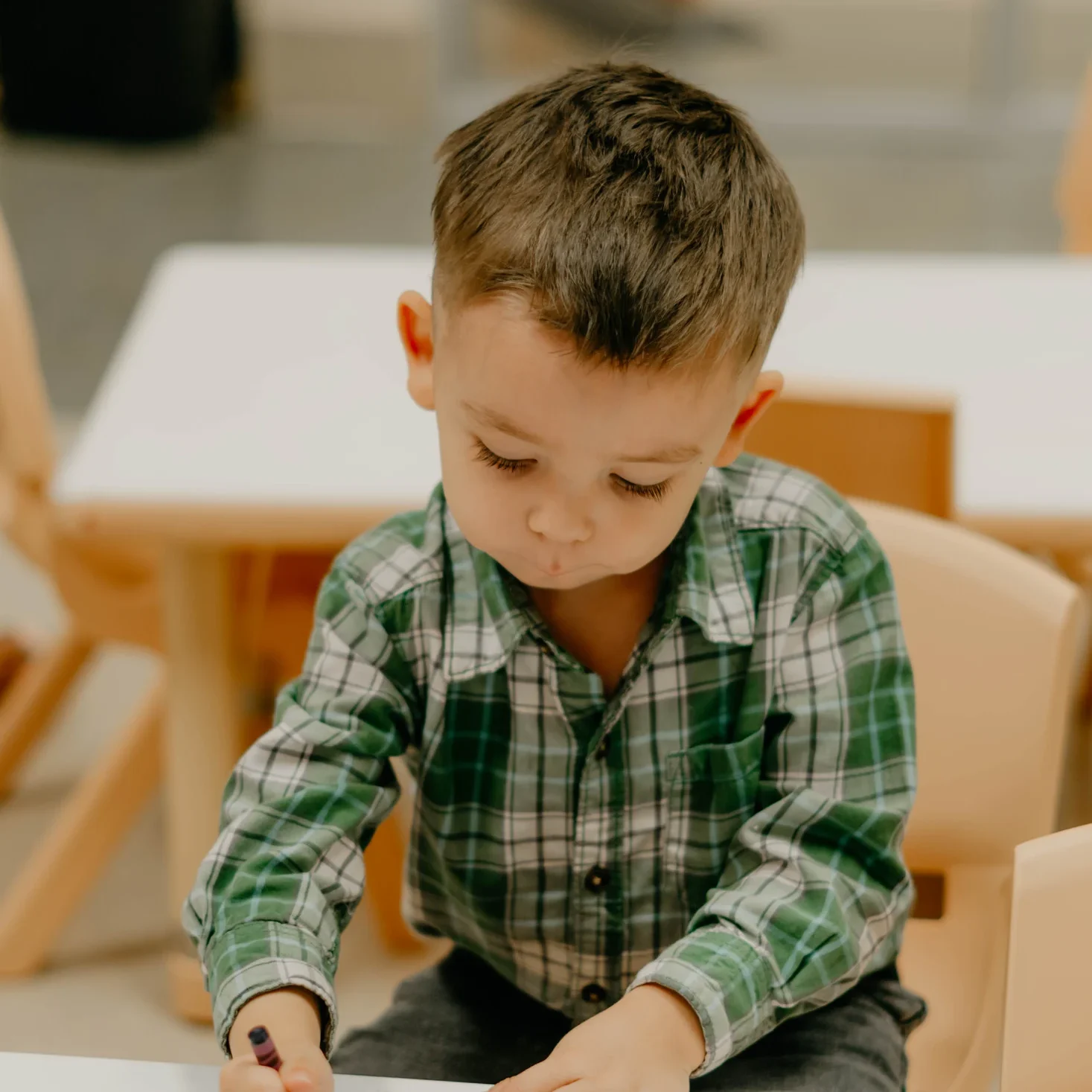 A boy coloring during Avenue Kids